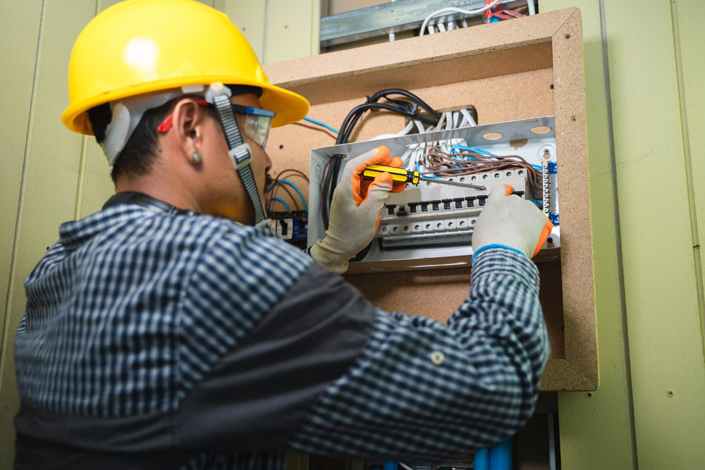 Residential Electrician in Rifle, CO Working On Panel