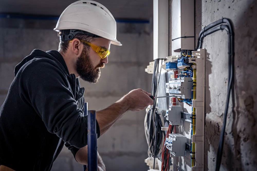 Commercial Electrician in Rifle, CO Checking Electrical Panel